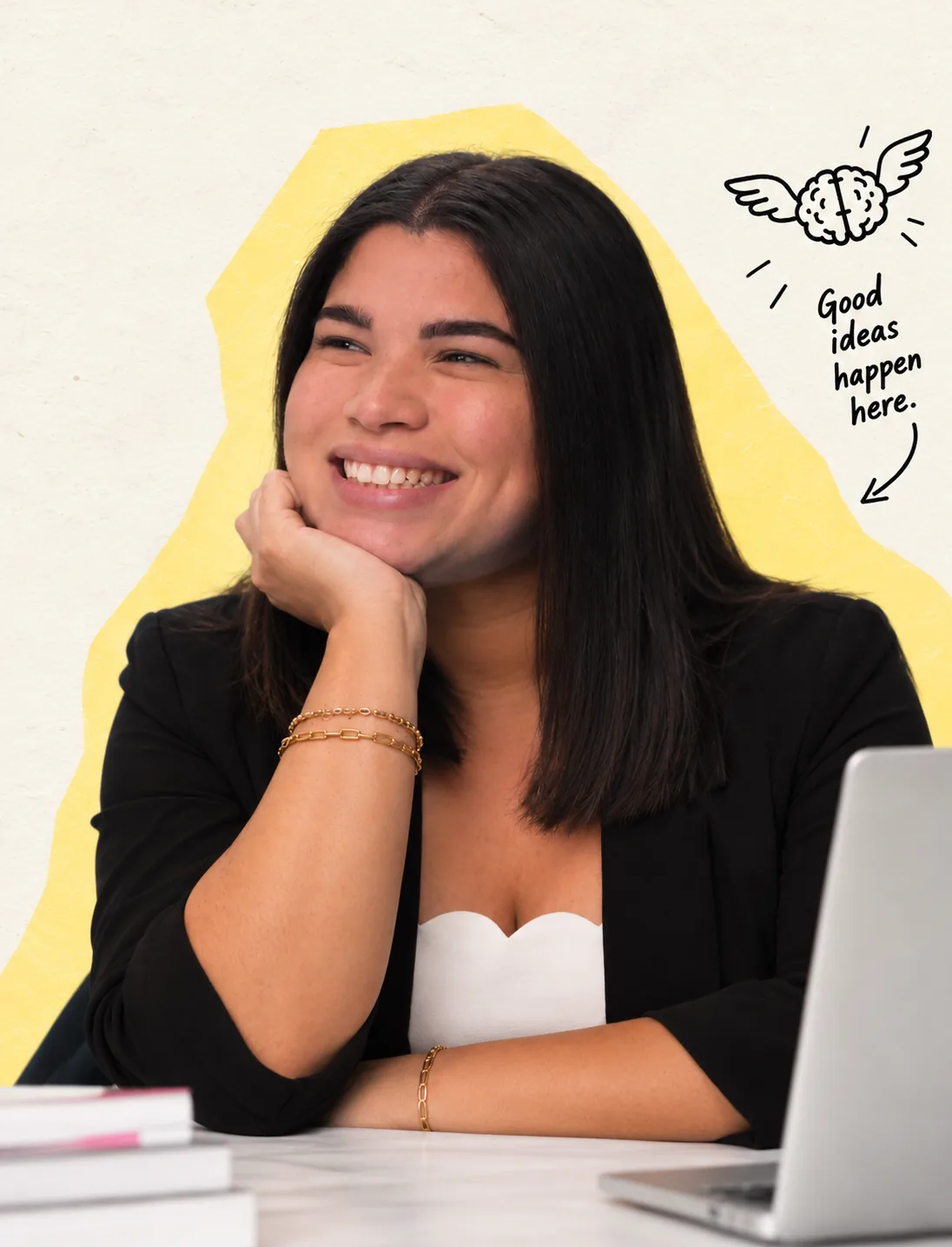 Ashlee smiling at a desk, resting her chin on her hand, with a winged brain illustration and yellow paper backdrop